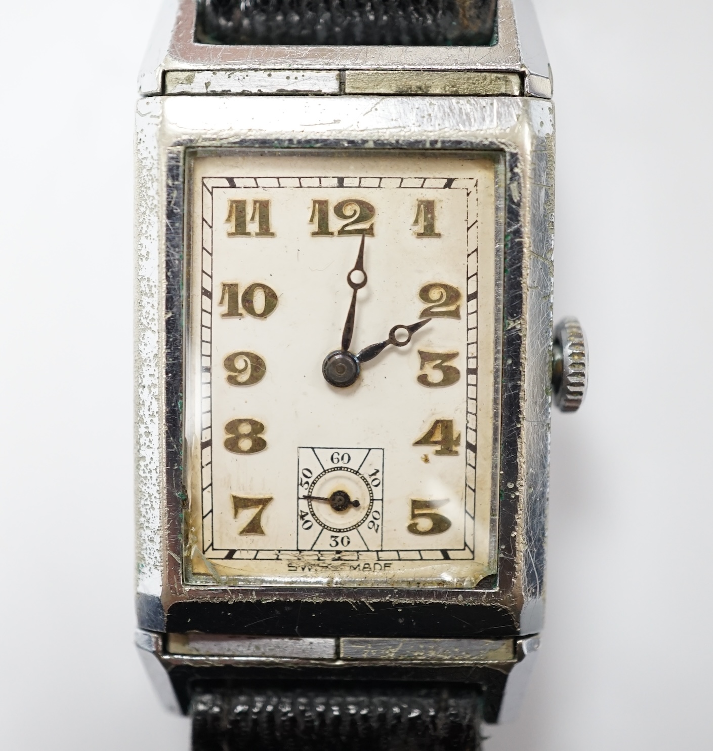 A gentleman's mid 20th century steel 'reverso' manual wind rectangular dial wrist watch, with Arabic dial and subsidiary seconds, the back with engraved initials and enamel.